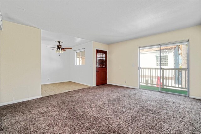 interior space with light carpet, ceiling fan, and a healthy amount of sunlight