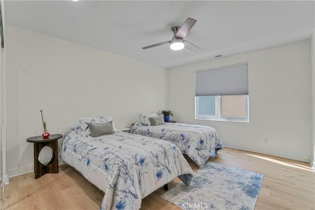 bedroom with ceiling fan and light wood-type flooring