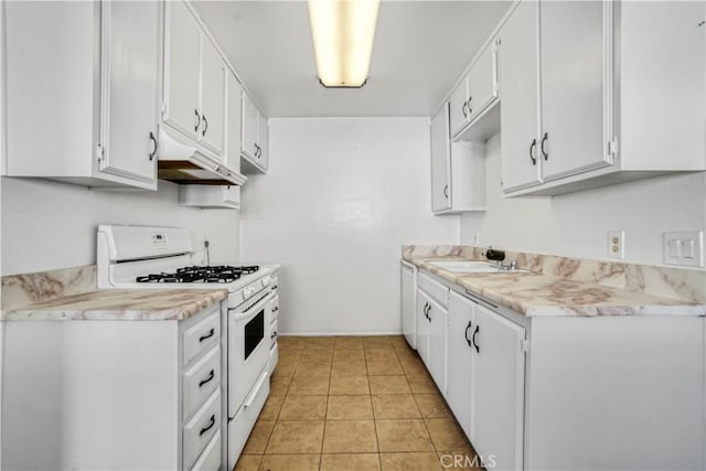 kitchen with white cabinetry, sink, white range with gas cooktop, and light tile patterned flooring