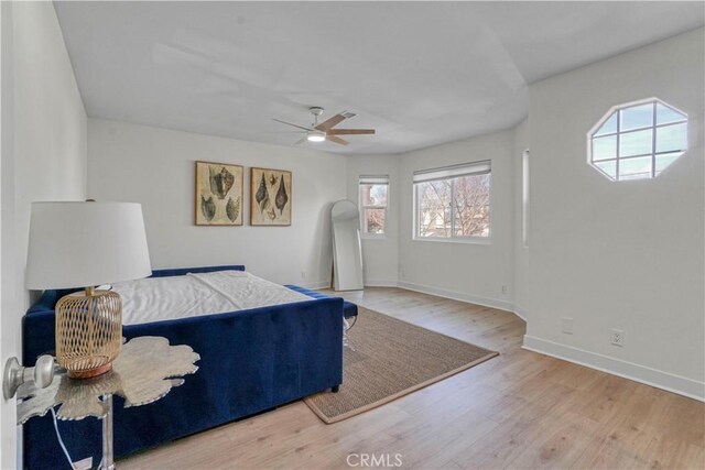 bedroom with light hardwood / wood-style flooring and ceiling fan