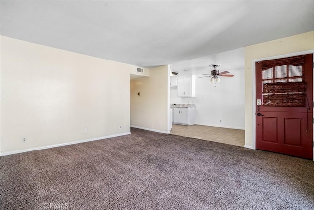 unfurnished living room featuring ceiling fan and light carpet