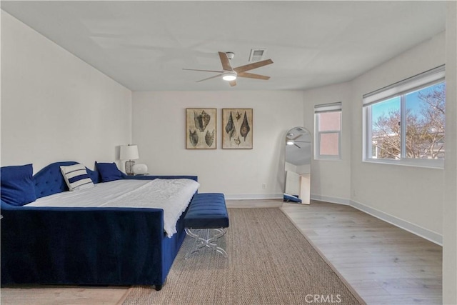 bedroom with hardwood / wood-style flooring and ceiling fan