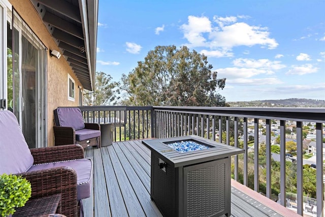 wooden terrace featuring an outdoor fire pit