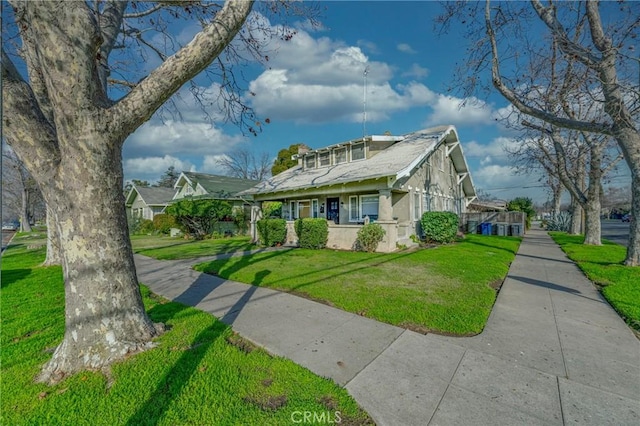 view of front of home with covered porch and a front yard