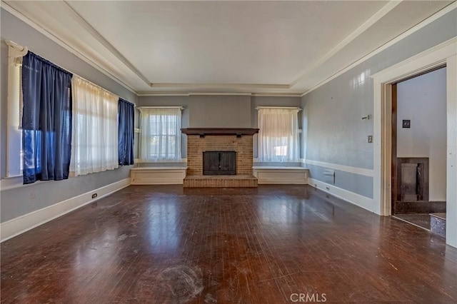 unfurnished living room with dark wood-type flooring, ornamental molding, and a fireplace