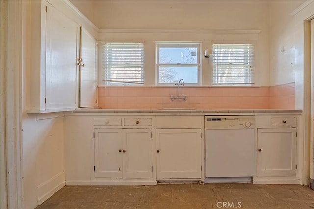 kitchen featuring sink, a wealth of natural light, white cabinets, and white dishwasher