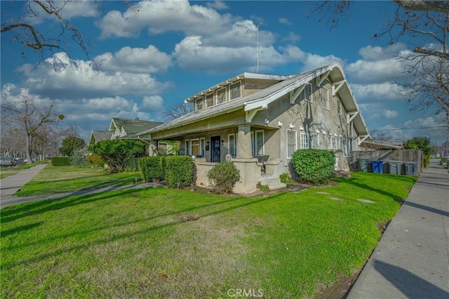 view of property exterior with a porch and a yard