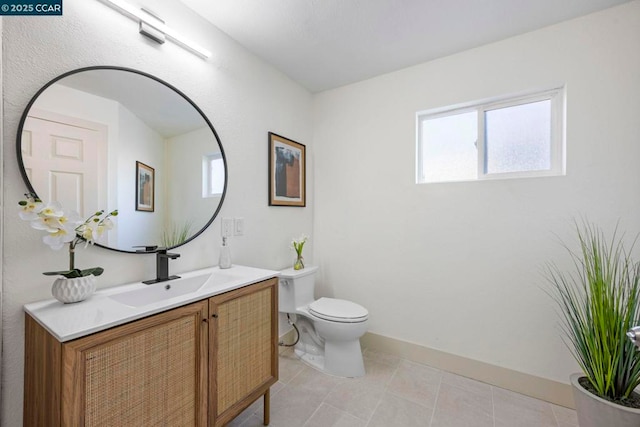 bathroom with vanity, tile patterned flooring, and toilet