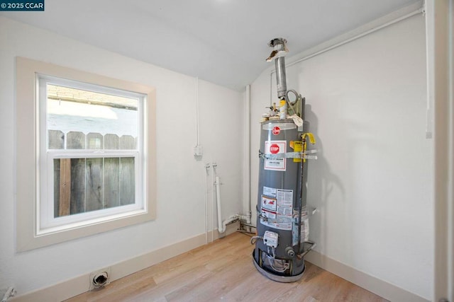 utility room with strapped water heater