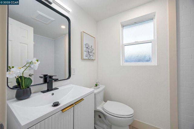 bathroom featuring vanity and toilet