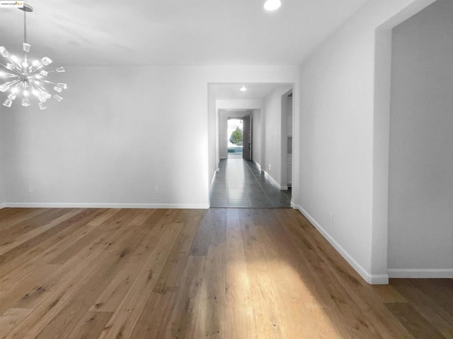 hallway with an inviting chandelier and dark hardwood / wood-style floors