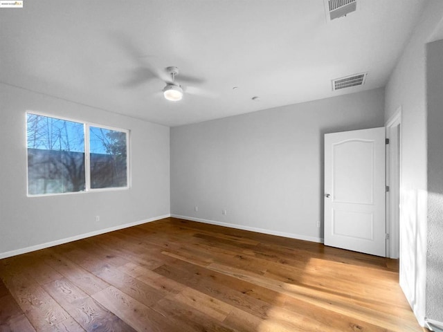 unfurnished room featuring hardwood / wood-style flooring and ceiling fan