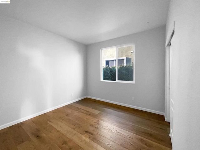 spare room featuring dark hardwood / wood-style floors