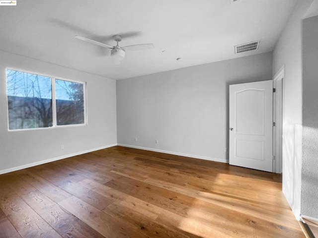 unfurnished room featuring hardwood / wood-style flooring and ceiling fan