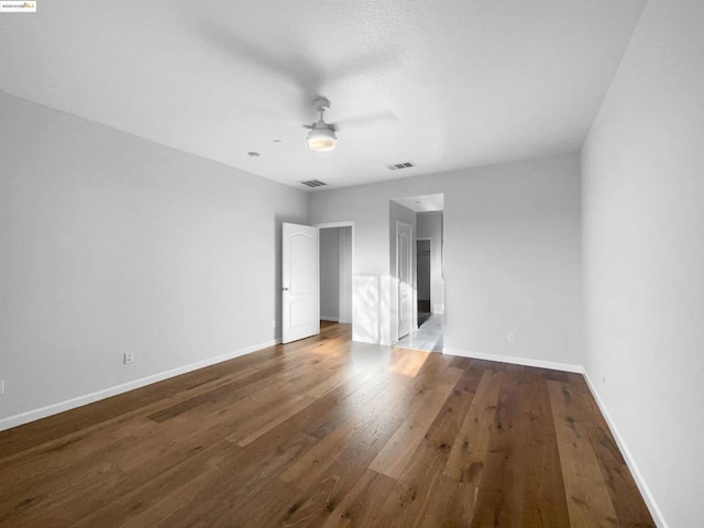 unfurnished bedroom with dark wood-type flooring and ceiling fan