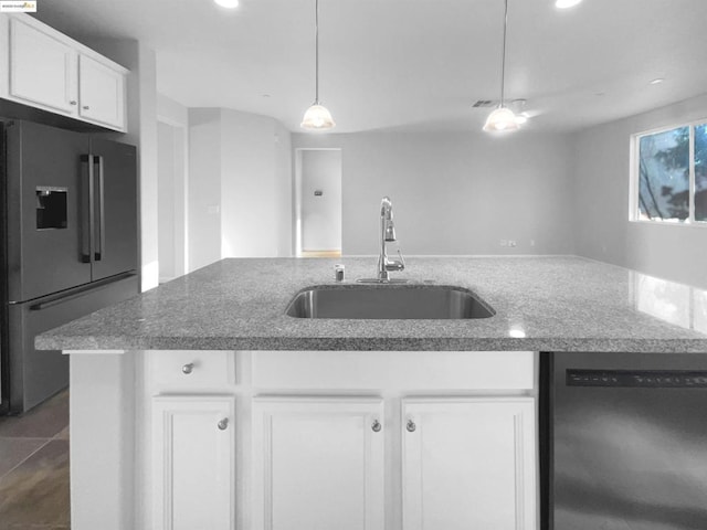 kitchen featuring high quality fridge, white cabinetry, sink, hanging light fixtures, and stainless steel dishwasher