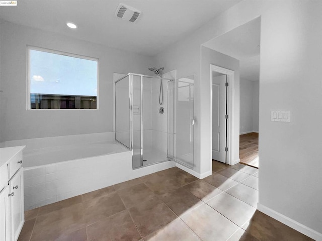 bathroom featuring vanity, shower with separate bathtub, and tile patterned floors