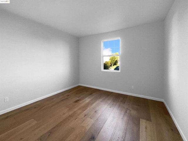 spare room with wood-type flooring