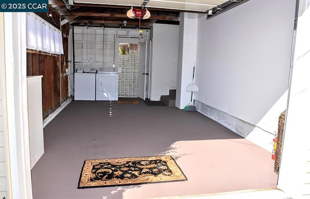 garage featuring washing machine and clothes dryer