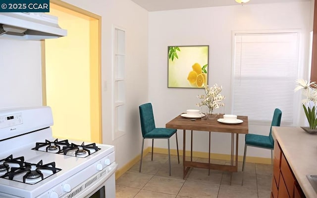 kitchen with light tile patterned flooring and white gas stove