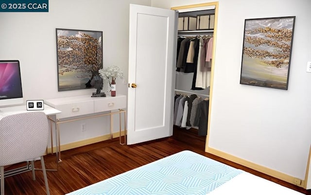 bedroom featuring dark hardwood / wood-style flooring and a closet