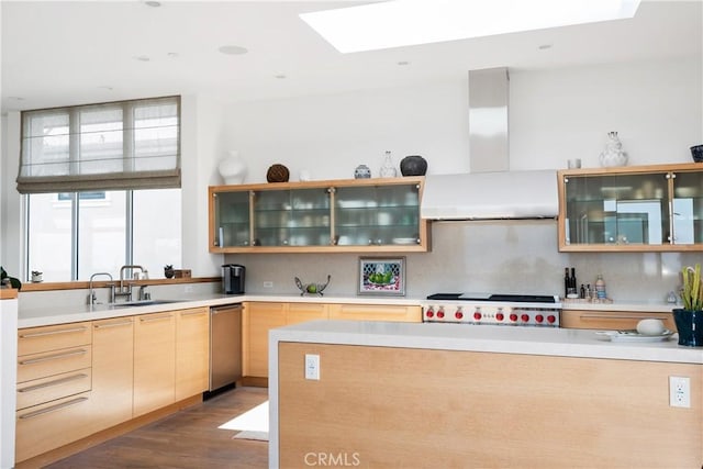 kitchen with tasteful backsplash, sink, light brown cabinets, range, and wall chimney range hood