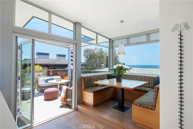 sunroom / solarium featuring a water view and breakfast area