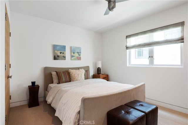 bedroom featuring light colored carpet and ceiling fan