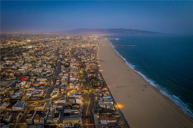 birds eye view of property with a water view and a view of the beach