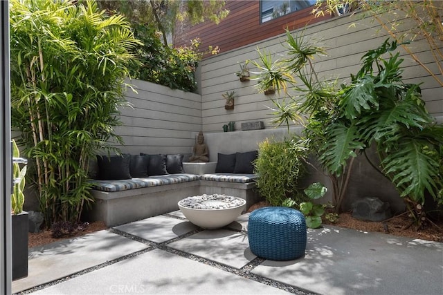 view of patio featuring outdoor lounge area and fence