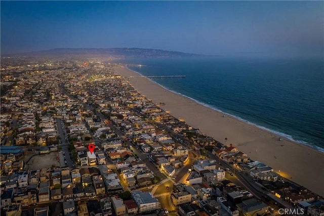 aerial view with a water view and a beach view