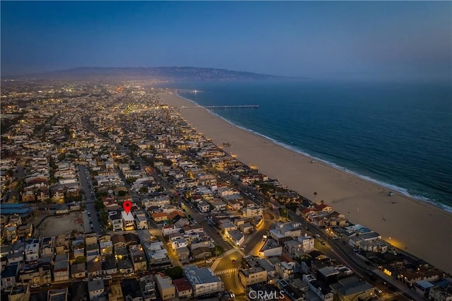 aerial view with a water view and a beach view