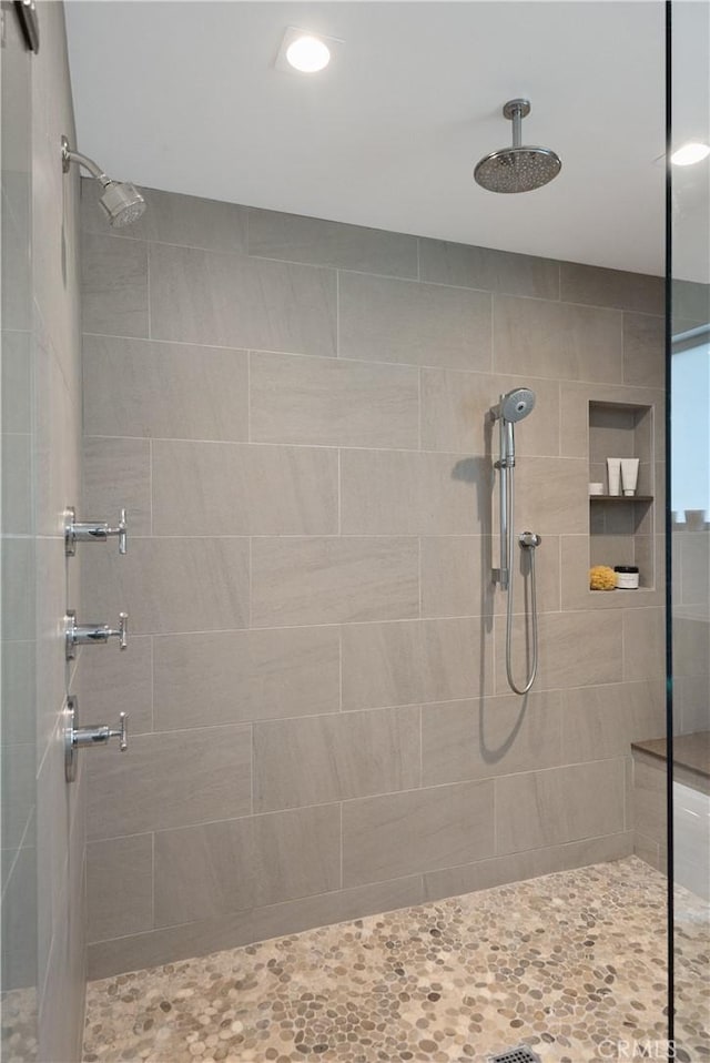 bathroom with recessed lighting and tiled shower