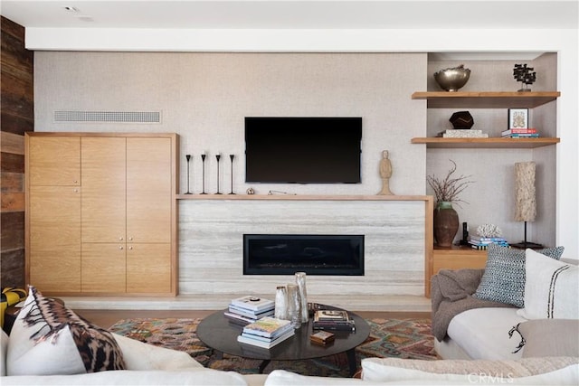 living area with visible vents and a premium fireplace