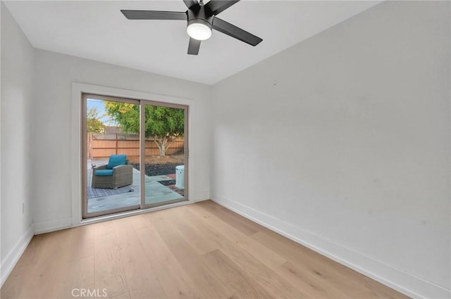 spare room with ceiling fan and light wood-type flooring