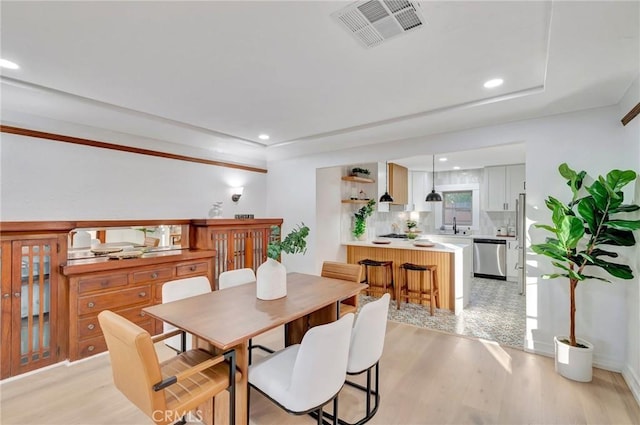 dining space with light wood-type flooring