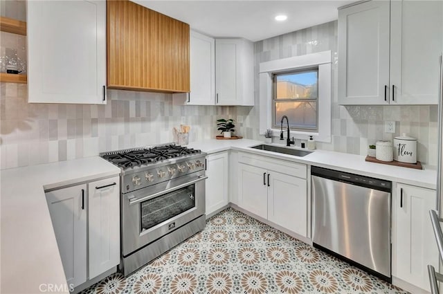 kitchen featuring white cabinetry, appliances with stainless steel finishes, sink, and tasteful backsplash