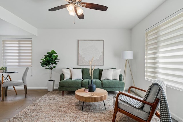 living room with ceiling fan and light tile patterned floors