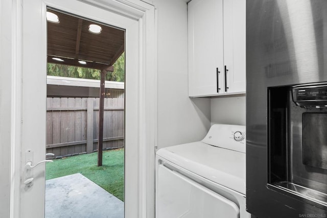 laundry room with washer / dryer and cabinets