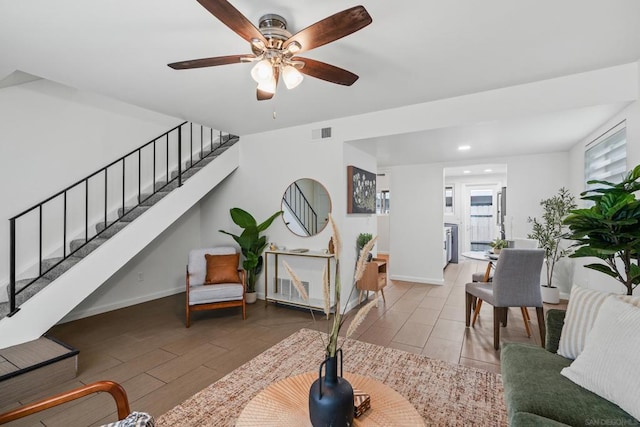 living room featuring ceiling fan and wood-type flooring