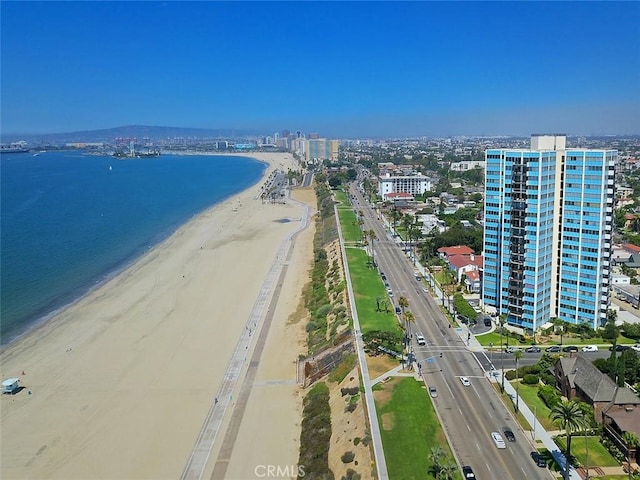 bird's eye view featuring a city view, a view of the beach, and a water view