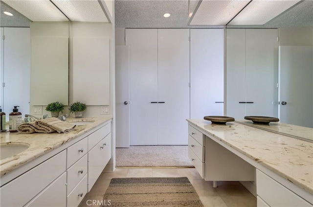 full bathroom with tile patterned flooring, double vanity, and a sink