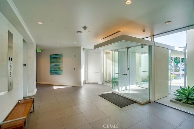 bathroom with expansive windows, recessed lighting, a shower stall, tile patterned flooring, and baseboards