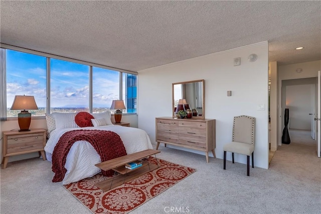 bedroom with a textured ceiling and light carpet