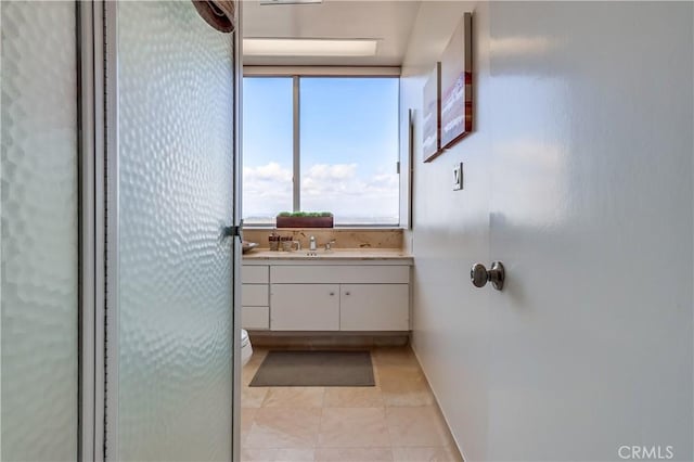 bathroom with tile patterned floors and vanity