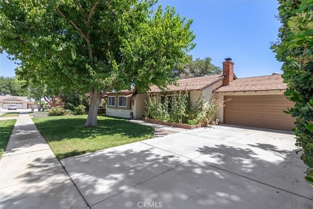 view of front of property with a garage and a front lawn