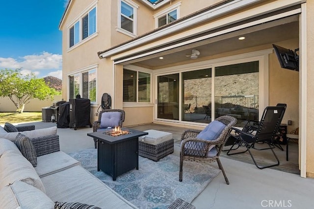 view of patio / terrace with an outdoor living space with a fire pit