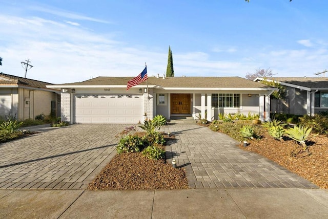 ranch-style home featuring a garage