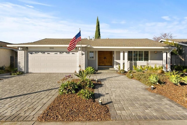 ranch-style home featuring a garage