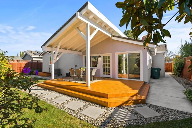 rear view of property featuring a wooden deck and central air condition unit